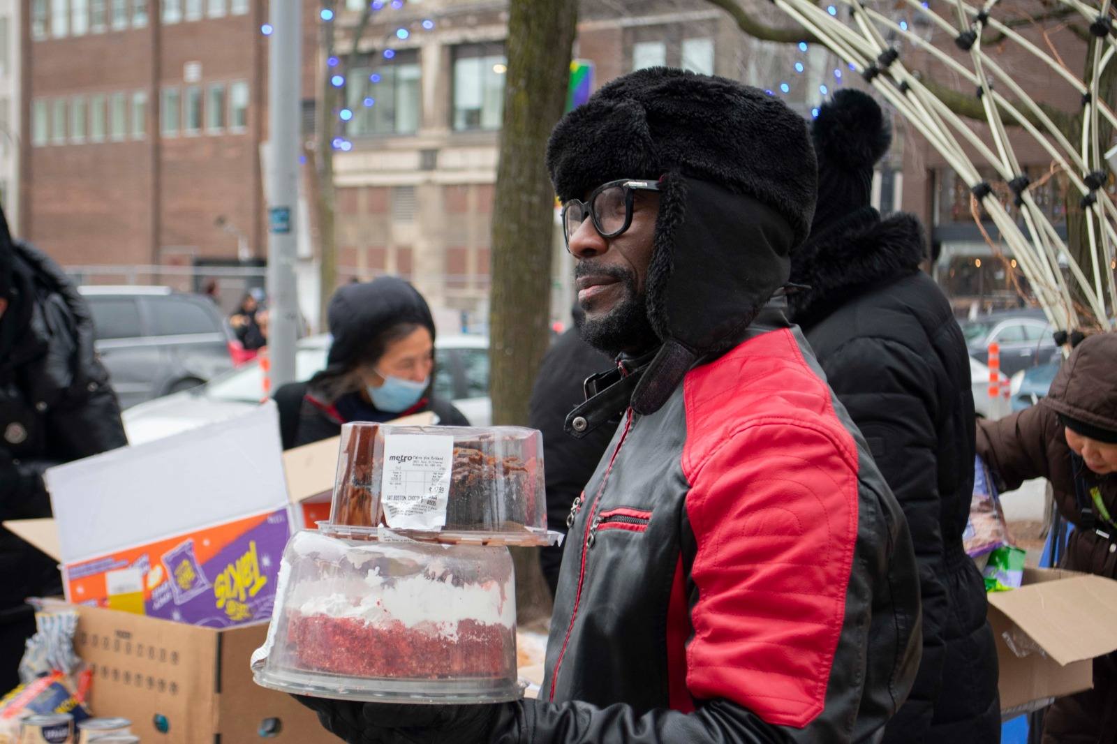 Volunteer carrying donated cake