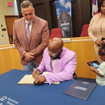 Founder signing official recognition documents