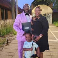 Founder with family at a recognition ceremony