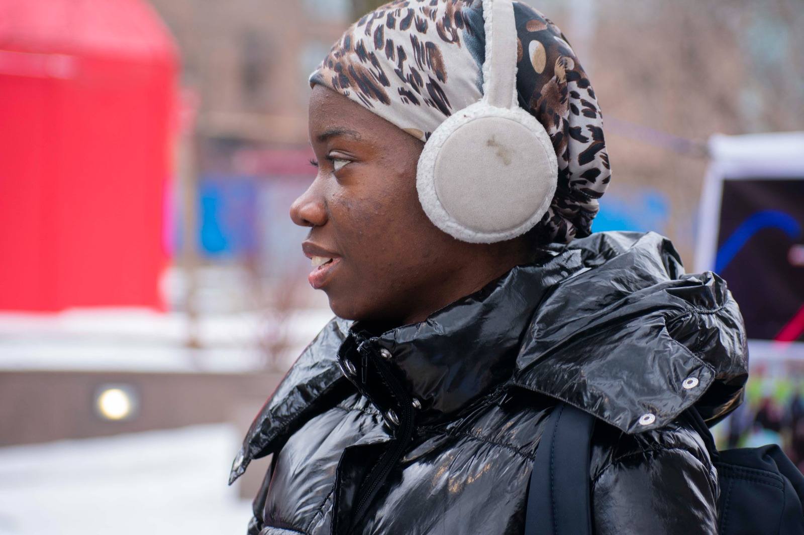 Young woman receiving warm gear in winter