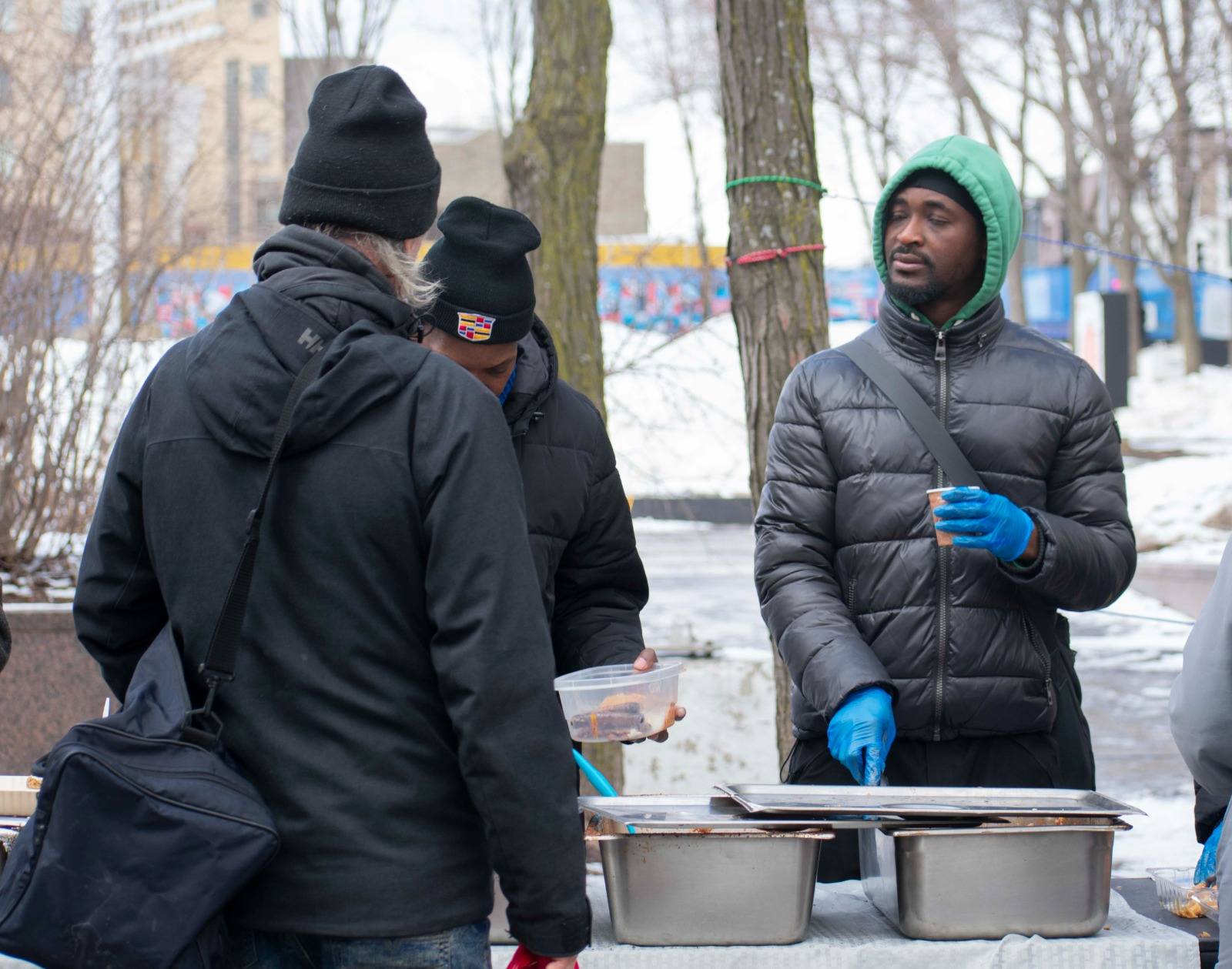 Volunteer serving hot meals to neighbours in need